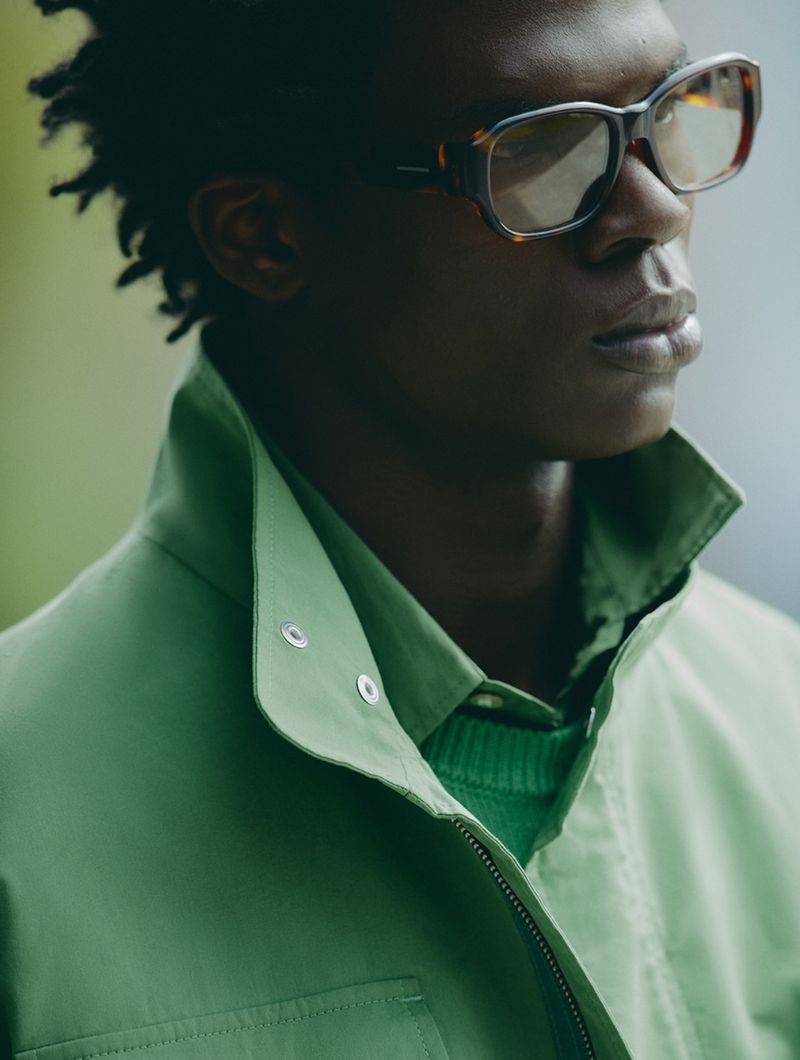 Black man wearing tortoiseshell sunglasses and a green jacket for a Zara Man campaign.