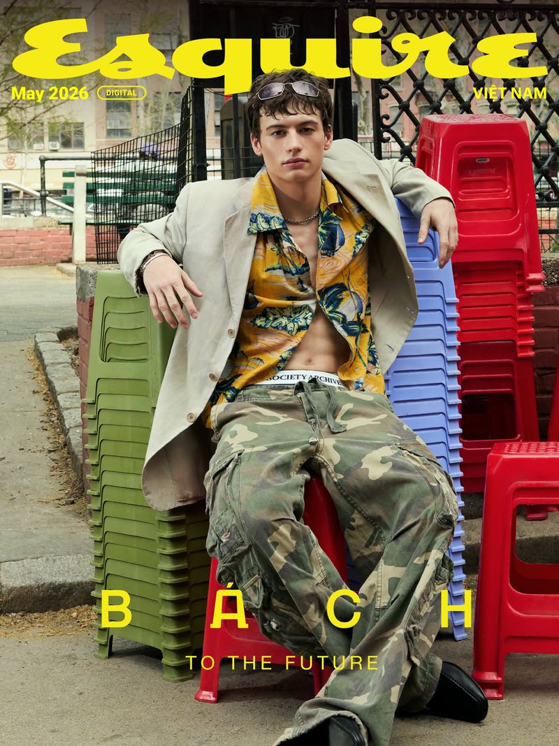 Esquire Magazine cover, May 2026: a young adult male in a beige blazer, patterned shirt and camo pants sits on stacked colored stools.