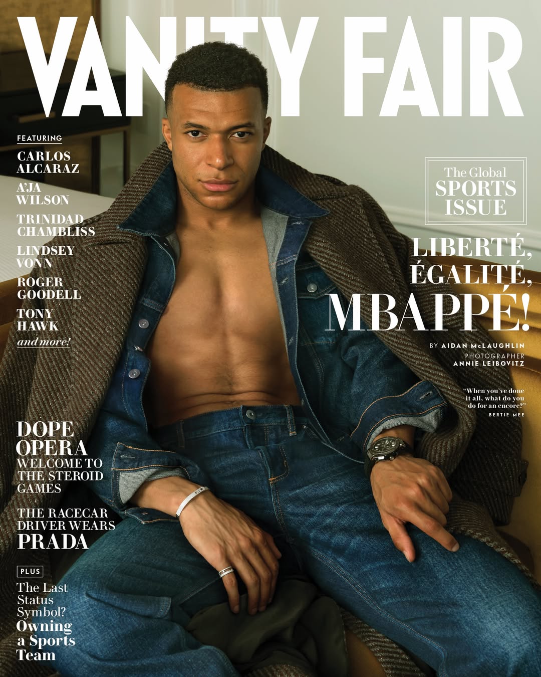 Vanity Fair cover featuring Kylian Mbappé in a denim jacket and jeans, with a tan coat draped over him, against a neutral backdrop.