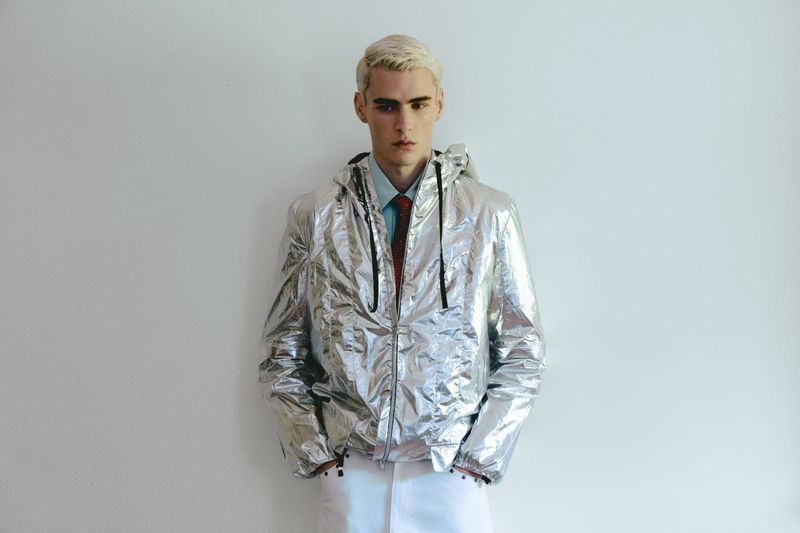 Model wearing a shiny silver metallic jacket against a plain white background for Vanity Teen Magazine