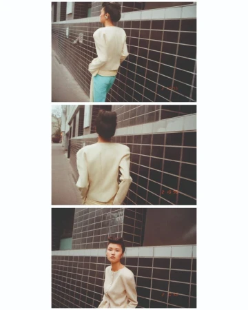 Model in a cream jacket and blue trousers walking past dark tiled walls in a three-panel vertical editorial photograph.
