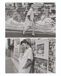 Model walking past a graphic roller shutter and leaning against a poster-covered alley wall in black and white