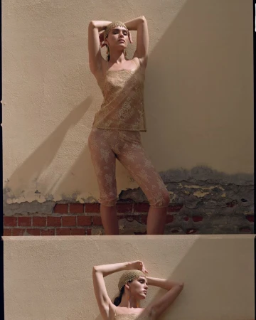 Model in lace top and capris posing against a textured wall with harsh sunlight casting dramatic shadows