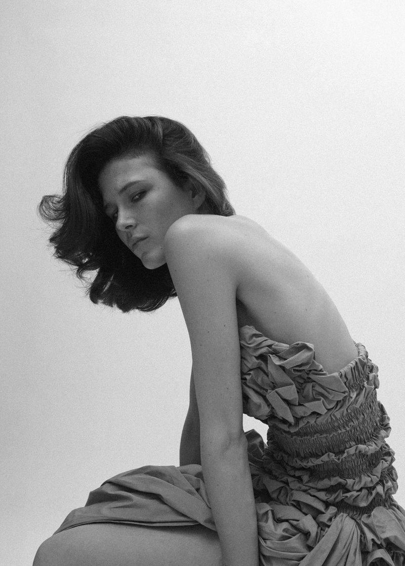 Model Lonneke Te Kloese in a ruched dress captured against a plain white background for Puss Puss Magazine