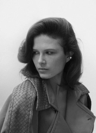 Model Lonneke Te Kloese wearing a woven leather coat in a fashion portrait for Puss Puss Magazine