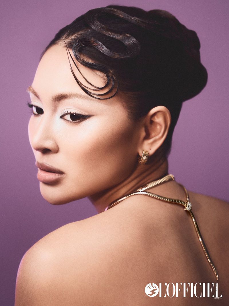 Close-up portrait of Nadine Lustre wearing a gold necklace and earrings against a purple background for L'Officiel Philippines.