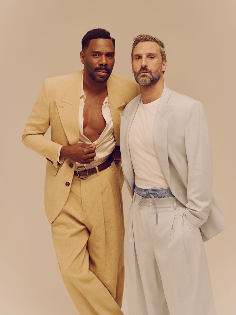 Colman Domingo and Marco Calvani posing together in tailored suits against a neutral background for Out Magazine editorial