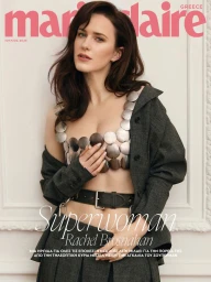 Rachel Brosnahan wearing a metallic disc crop top and charcoal suit on the Marie Claire Greece July 2025 cover.
