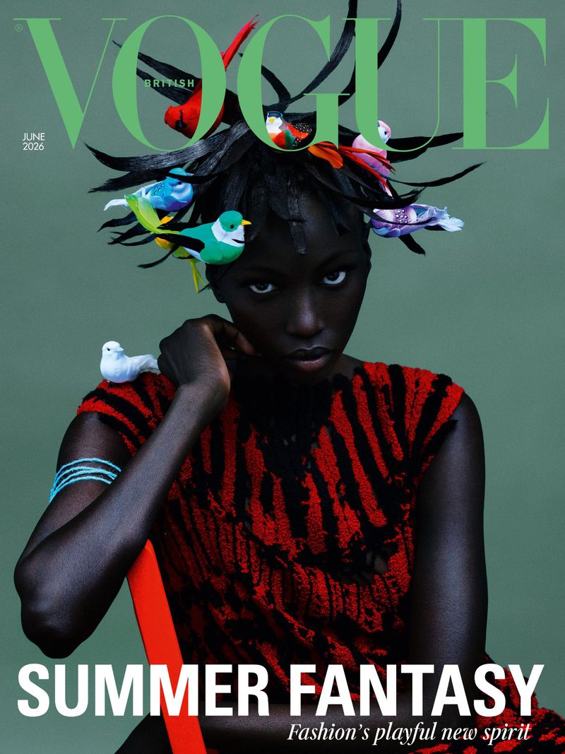British Vogue cover featuring a Black female model in red and black dress with small birds on her head, against a sage green backdrop.