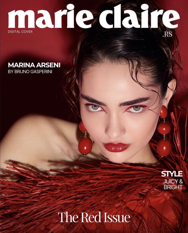 Marie Claire cover featuring Marina Arseni in red tones with bold red eye makeup, lips, and large red sphere earrings.