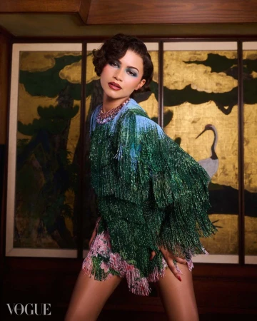 Zendaya wearing a green fringed garment against a Japanese-style gold leaf painted screen for Vogue Brasil May 2026