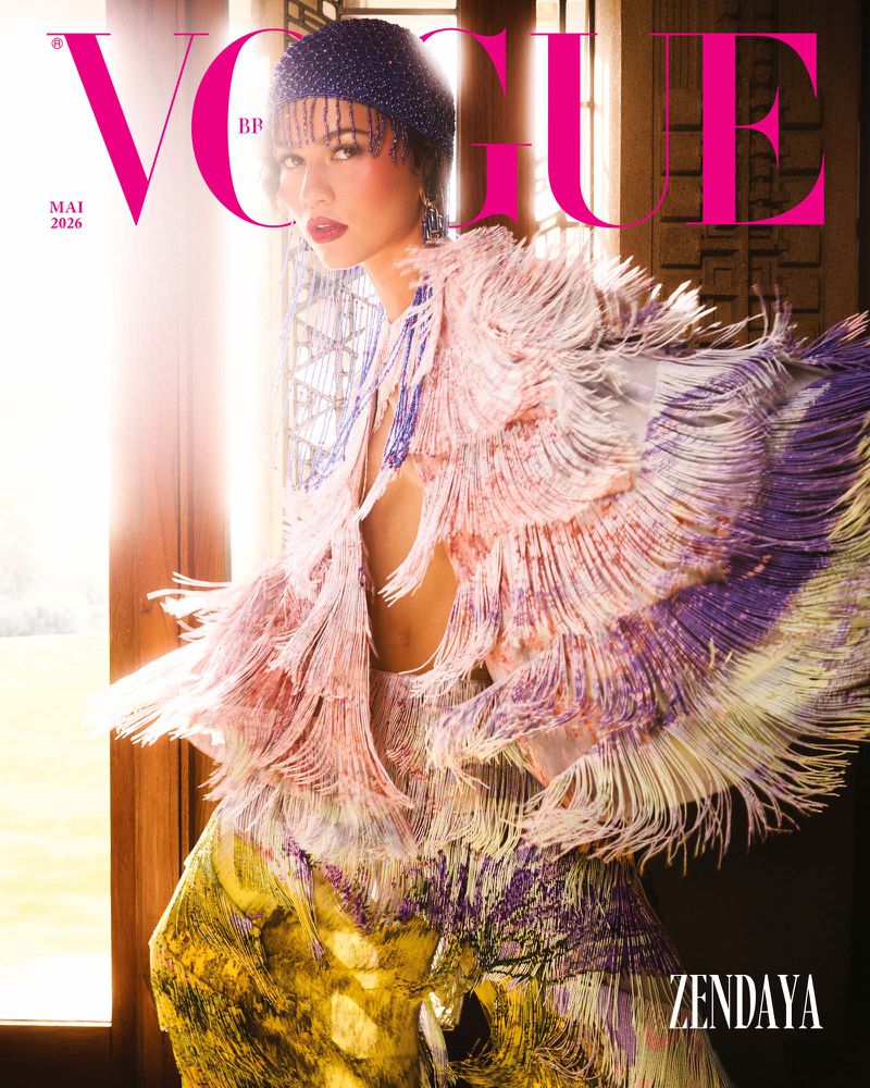Zendaya on the cover of Vogue Brazil, May 2026, wearing a fringed shawl and beaded headpiece, against a light-filled architectural setting.