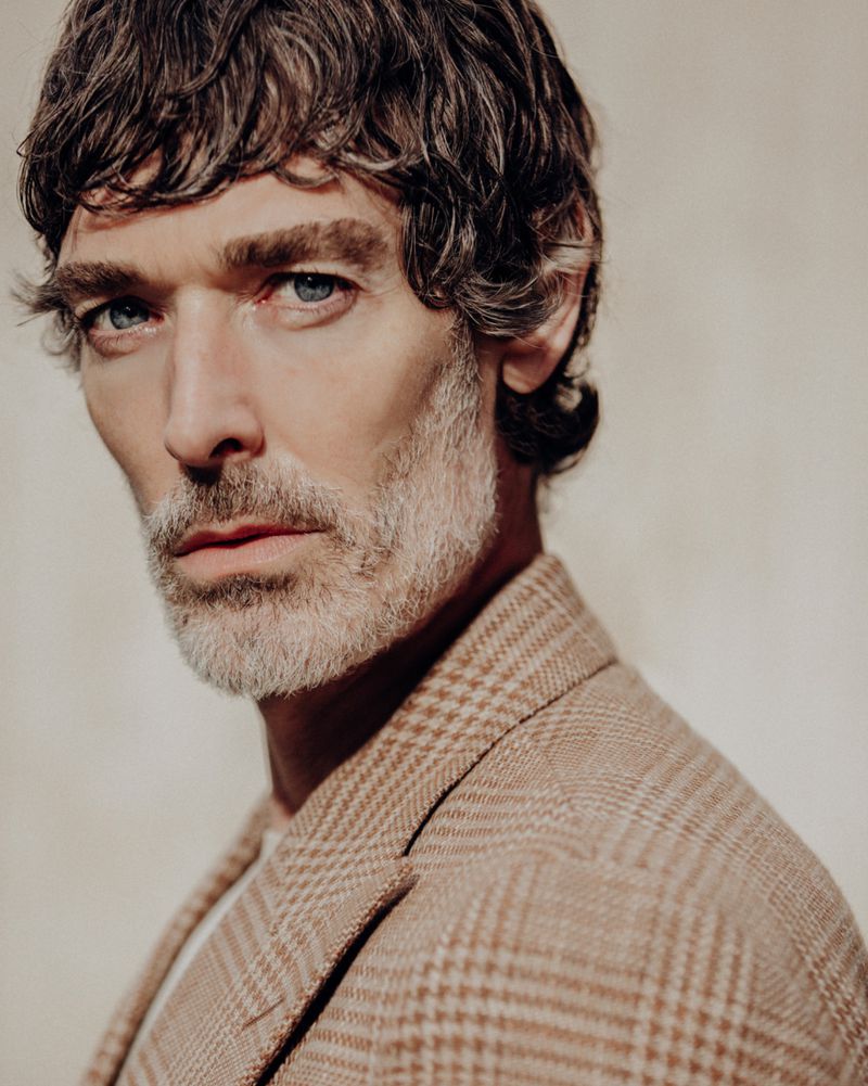 Close-up portrait of Richard Biedul wearing a houndstooth blazer for the MANGO Tailored By Richard James collection.