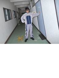 Man wearing a grey track suit and sunglasses posing in a hallway with a star-shaped object on the floor for Office Magazine.