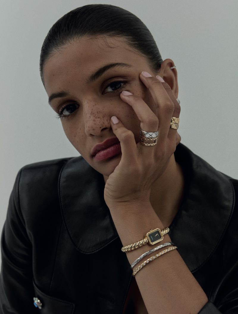 Close-up portrait of model Aliona Debeaud wearing stacked rings and a luxury watch for Mojeh Magazine.