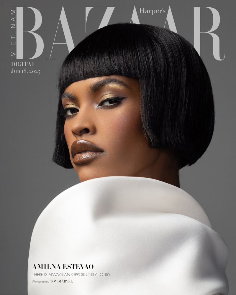 Harper's Bazaar cover featuring a close-up of a woman with a short bob haircut, glossy makeup, and a white coat against a grey backdrop.