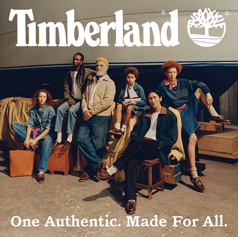 Group of six diverse models posing together wearing casual denim apparel and boat shoes for Timberland campaign