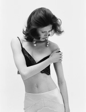 Model wearing a black lace bralette and light skirt against a plain white background for Le Figaro.