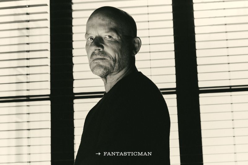 Portrait of Vincent Van Duysen in profile against window blinds for Fantastic Man China by Marcello Junior Dino