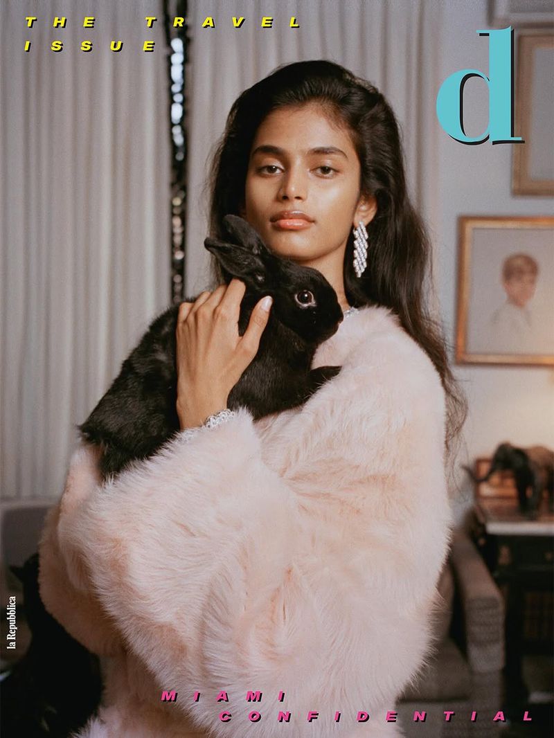 Model Bhavitha Mandava holding a black rabbit in a pink furry coat for D Repubblica cover