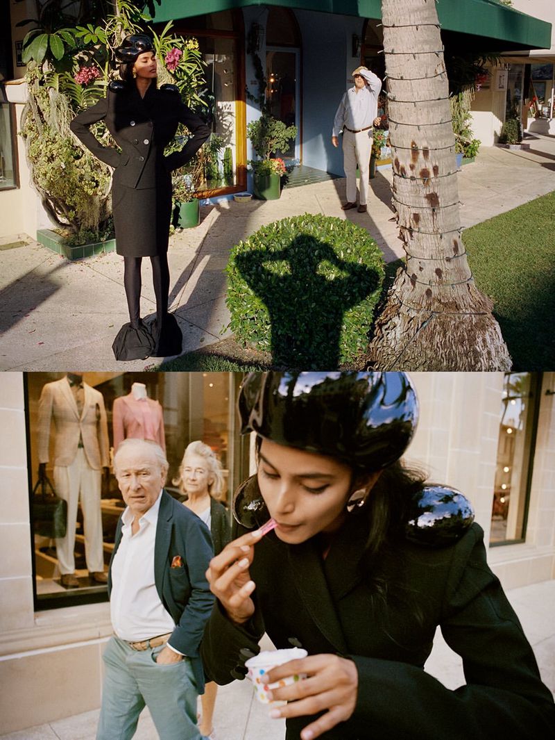 Model wearing a black jacket and matching skirt standing outdoors on a sunny street for D Repubblica editorial.