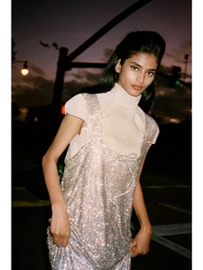 Model Bhavitha Mandava wearing a sparkling rhinestone dress outdoors at dusk for D Repubblica magazine cover.