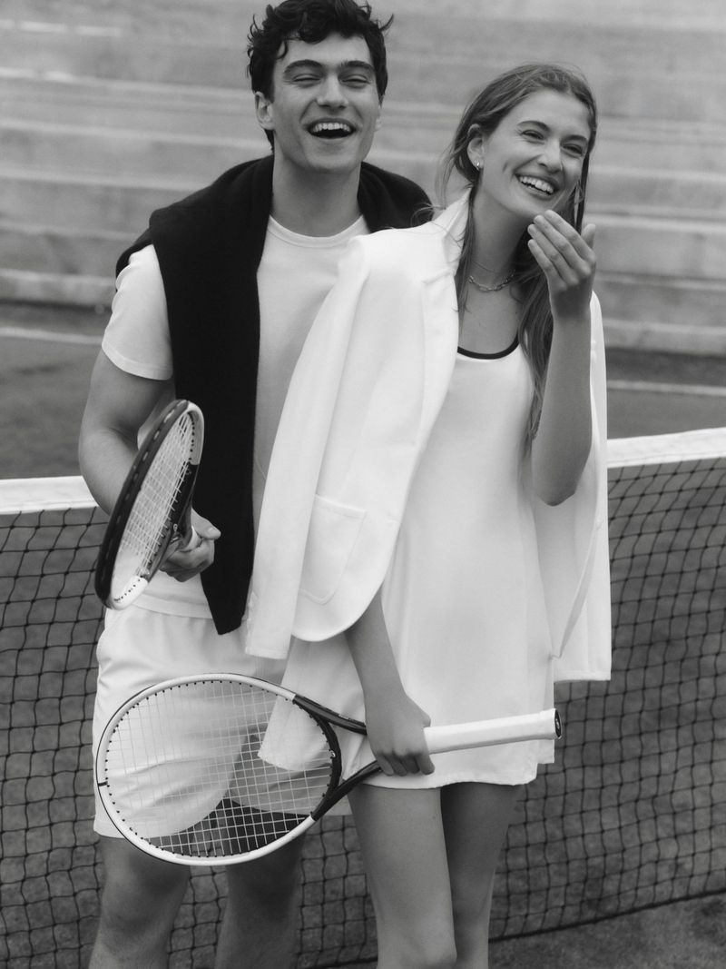 Smiling man and woman holding tennis rackets on a court for Tuckernuck Summer 2026
