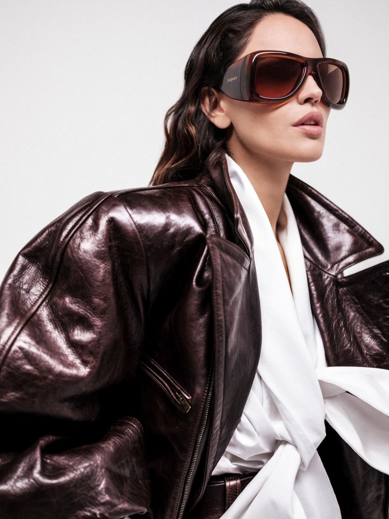 Eiza Gonzalez wearing dark sunglasses and a brown leather jacket for Numero Netherlands editorial