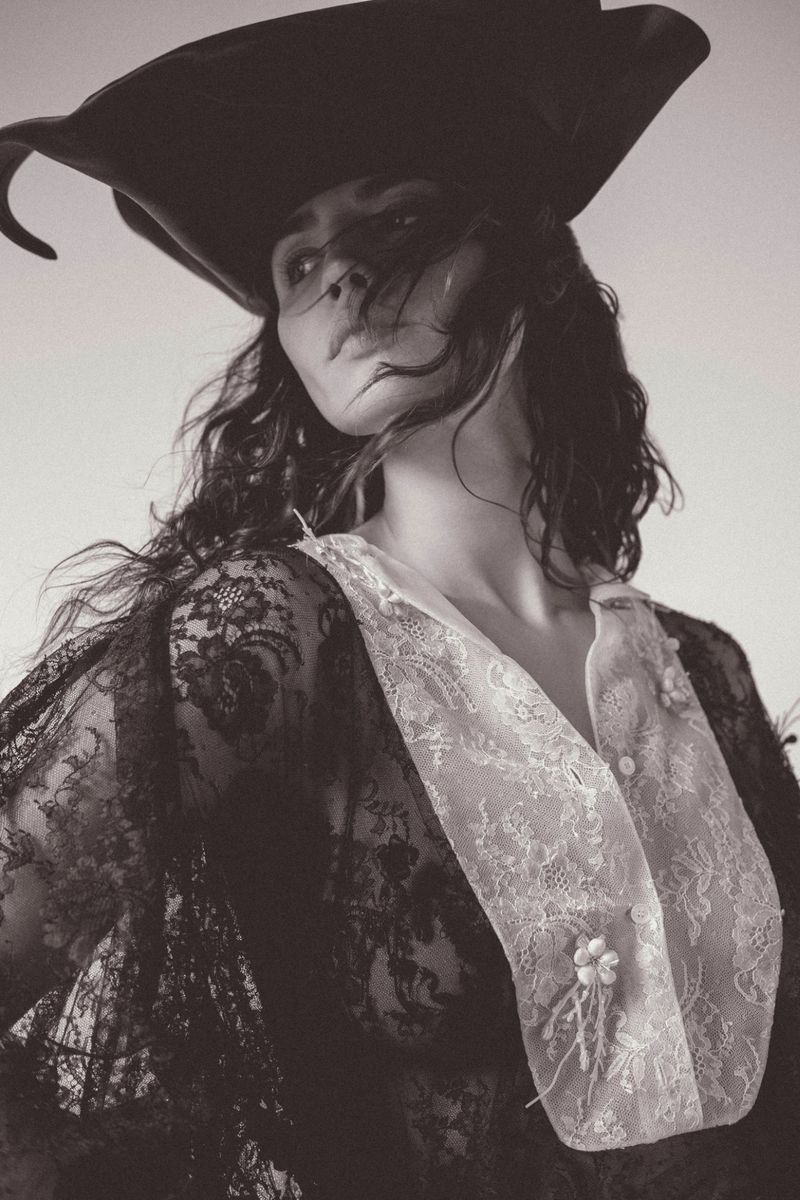 Portrait of Eiza Gonzalez wearing a black wide-brimmed hat and lace top for Numero Netherlands, photographed by JuanKr.