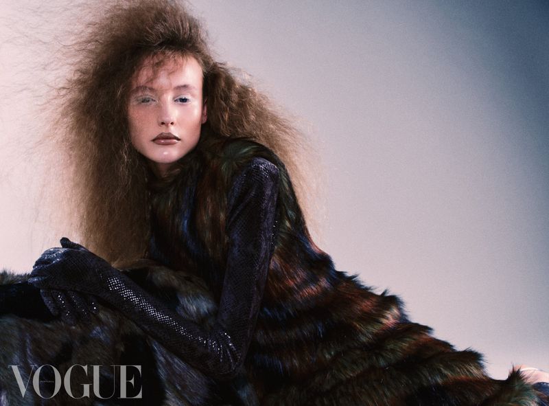 Model with voluminous hair wearing a textured dark dress and gloves for Vogue Portugal Soffice Porcellana
