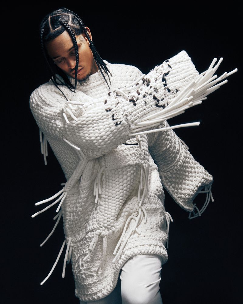 Jordan Clarkson wearing a textured white knit sweater with protruding fringes against a black background