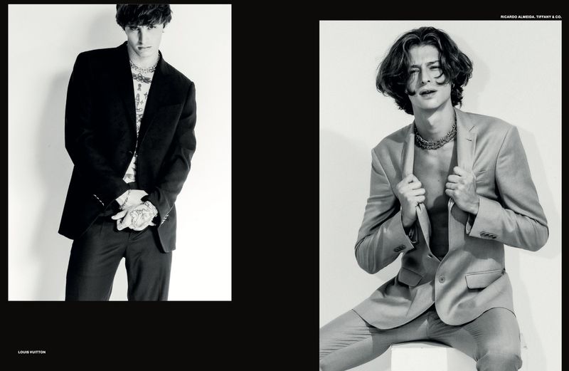 Black and white editorial fashion portrait of two male models wearing tailored suits against a plain white background for Numera Homem Brasil.