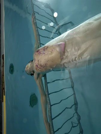 Underwater portrait of a person submerged in a pool next to a metal ladder, captured for Re-Edition Magazine.