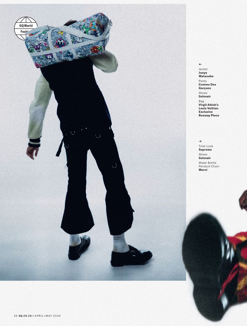 Model carrying a patterned duffel bag on their shoulder against a light grey studio backdrop with editorial layout text.
