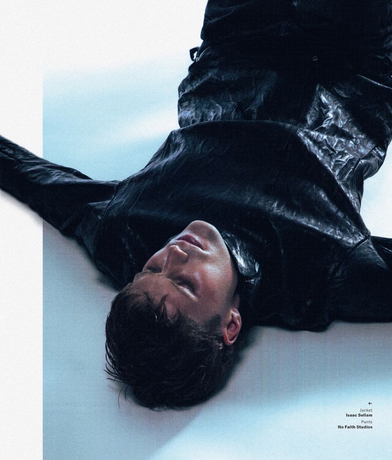 Model Nick Truelove lying on a bright background wearing dark textured clothing for GQ South Africa Must be True-Love project