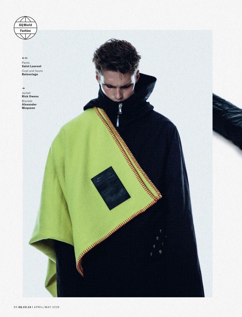 Model wearing black hoodie and vibrant lime green blanket draped over shoulder against a white studio background.