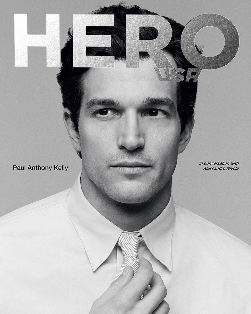 Portrait of Paul Anthony Kelly wearing a white shirt and tie for HERO USA magazine cover