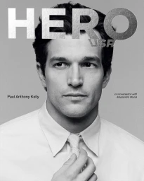 Portrait of Paul Anthony Kelly wearing a white shirt and tie for HERO USA magazine cover