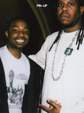 Two black men standing together indoors with PIN-UP branding visible at the top.