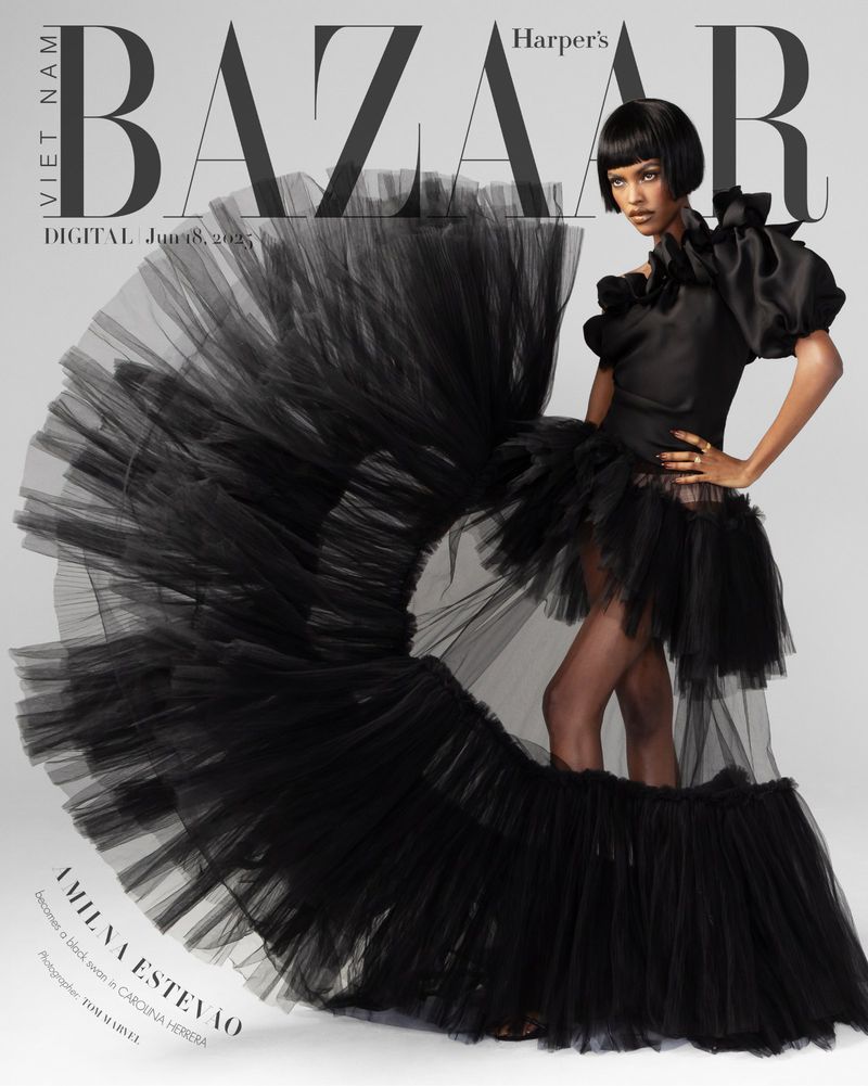 Fashion editorial shot of a woman in a black gown with a voluminous skirt. The image is a cover for Harper's Bazaar Vietnam.
