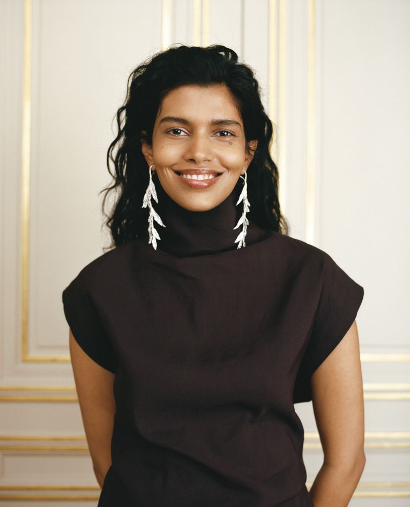 Model Pooja Mor wearing long silver leaf earrings and dark turtleneck for Neptune Papers Boucheron Special