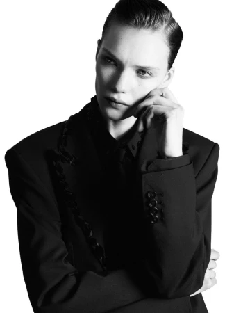 Model Penelope Ternes wearing a structured black blazer against a bright white background