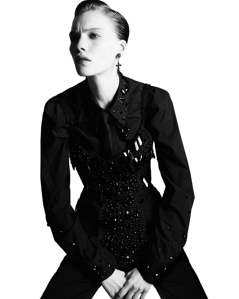 Model Penelope Ternes wearing a black embellished shirt against a bright white background