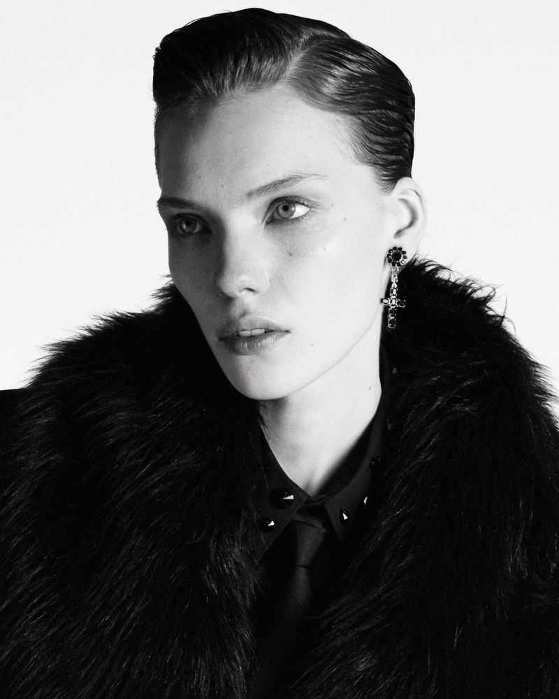 Model Penelope Ternes wearing a dark fur collar and collared shirt against a white background in a black and white portrait.