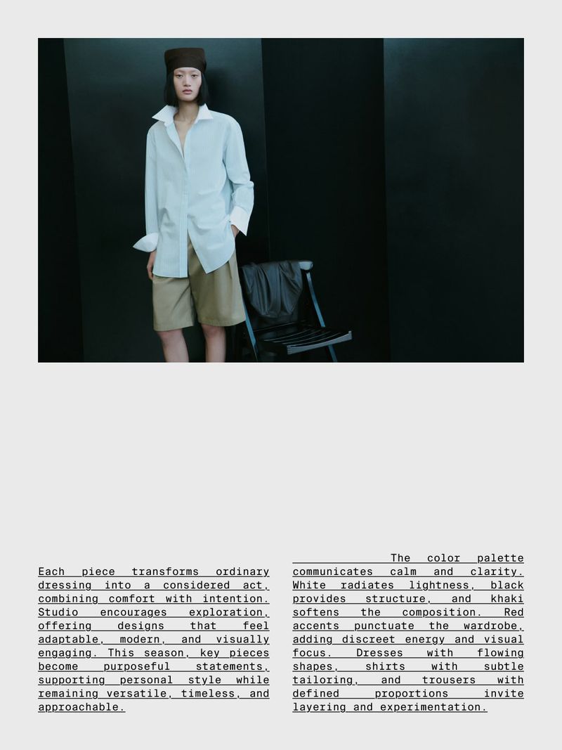 Model wearing a white oversized shirt and khaki shorts posing in a dark studio interior for Massimo Dutti