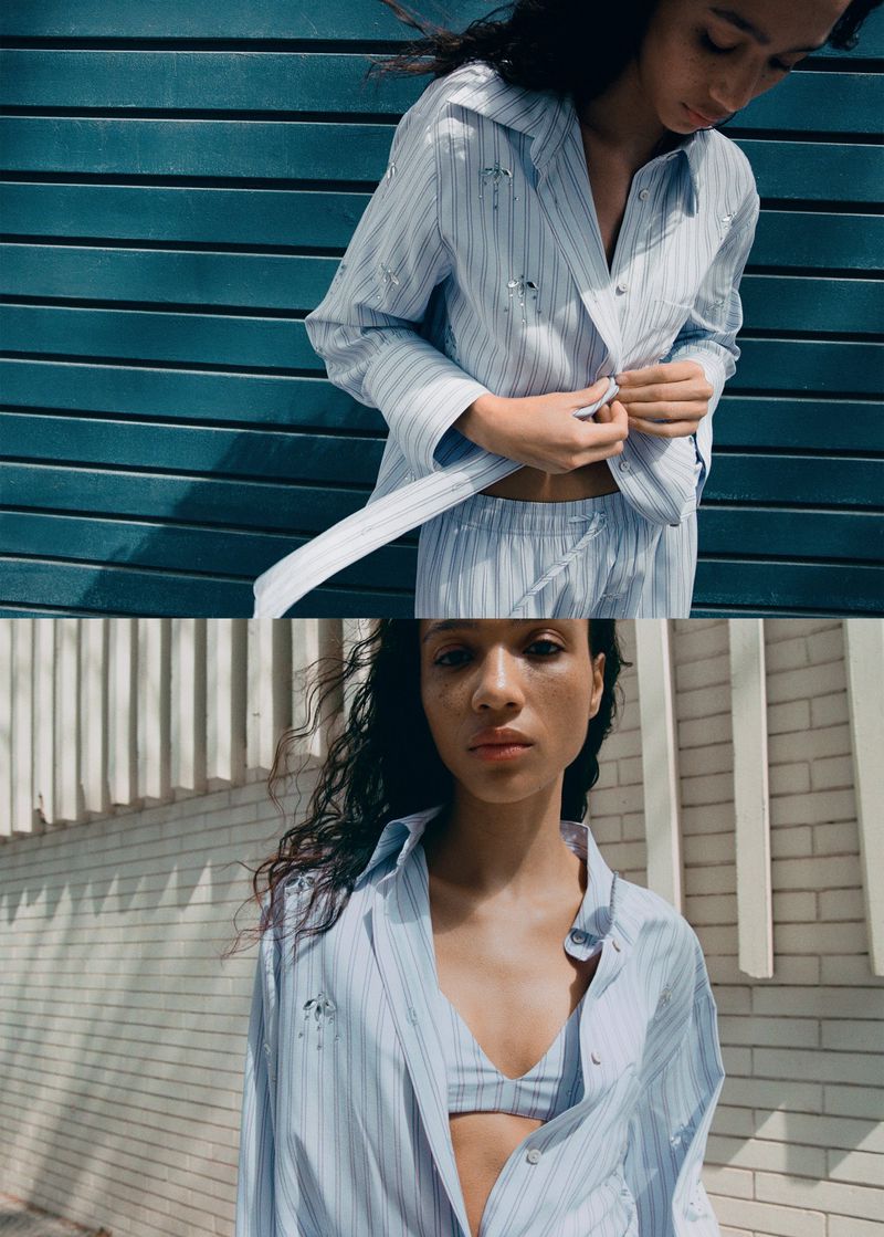 Model Mauria Caetano in a blue striped shirt and matching trousers against a textured wall for Mango.
