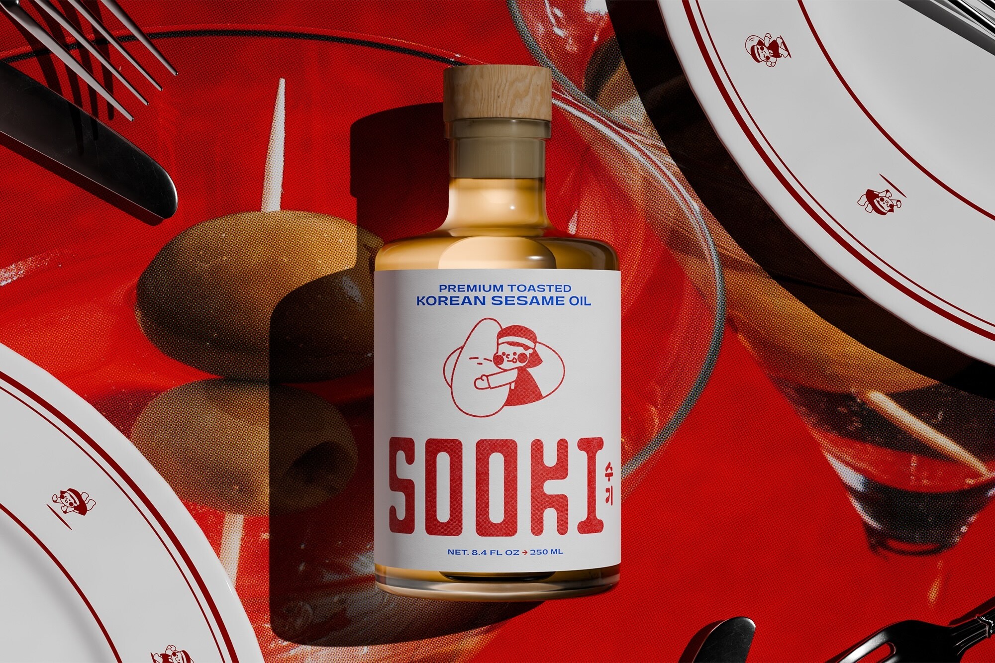 Bottle of Sooki sesame oil on a vibrant red placemat surrounded by plates and cutlery.