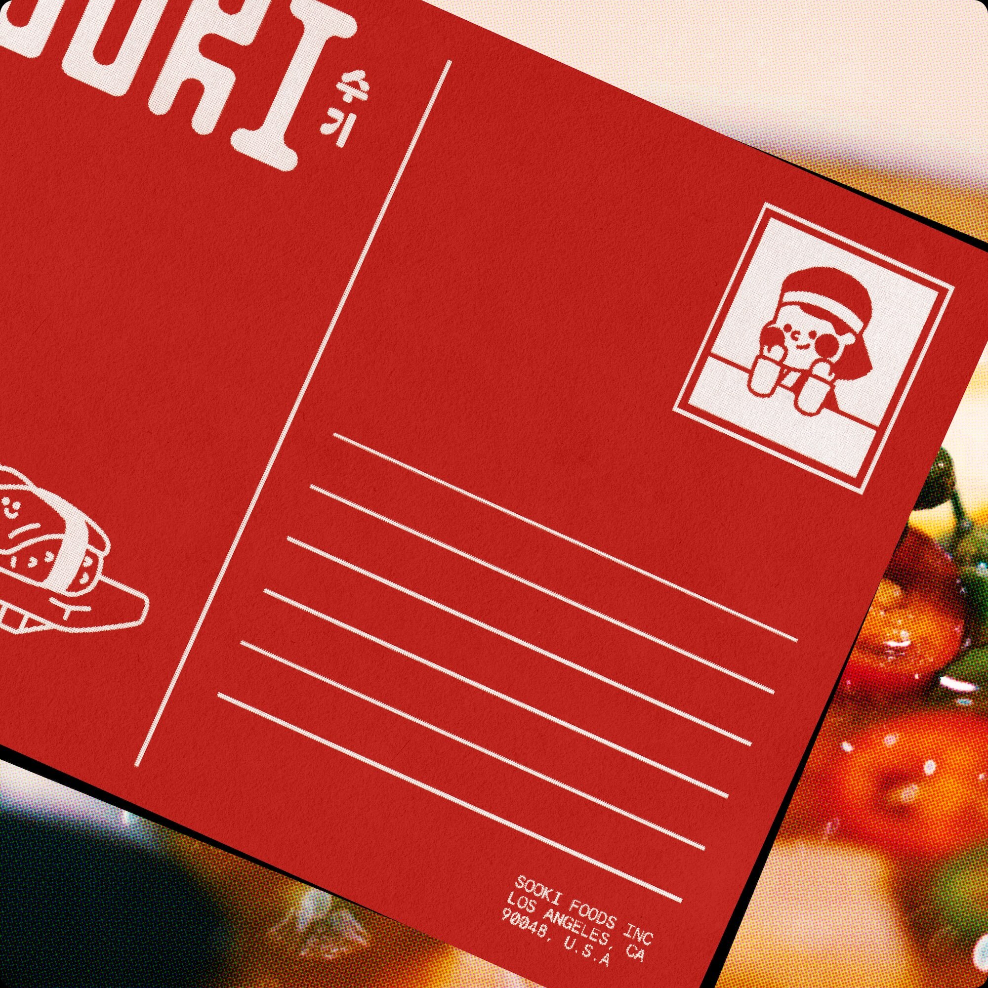 Red postcard design with white graphic illustrations and lines for writing against a blurred food background
