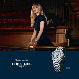Jennifer Lawrence leaning against a theater balcony in a dark dress, alongside a Longines watch advertisement.