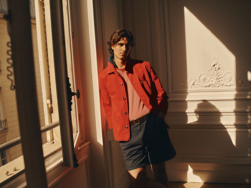 Man leaning against a wall in an interior with sunlight streaming through a window for the Zara Summer Cities project
